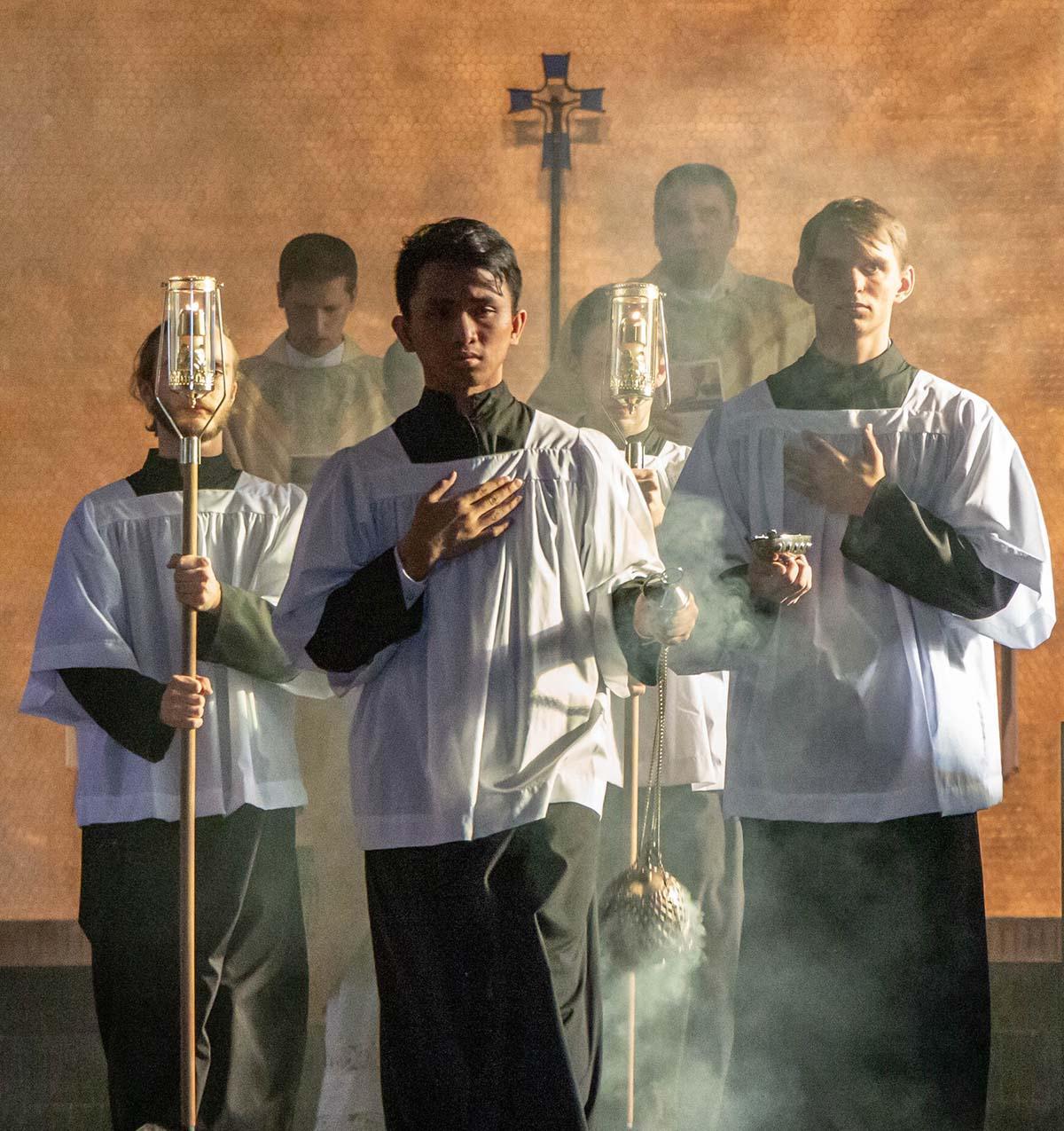 Altar servers leading Mass recessional with incense